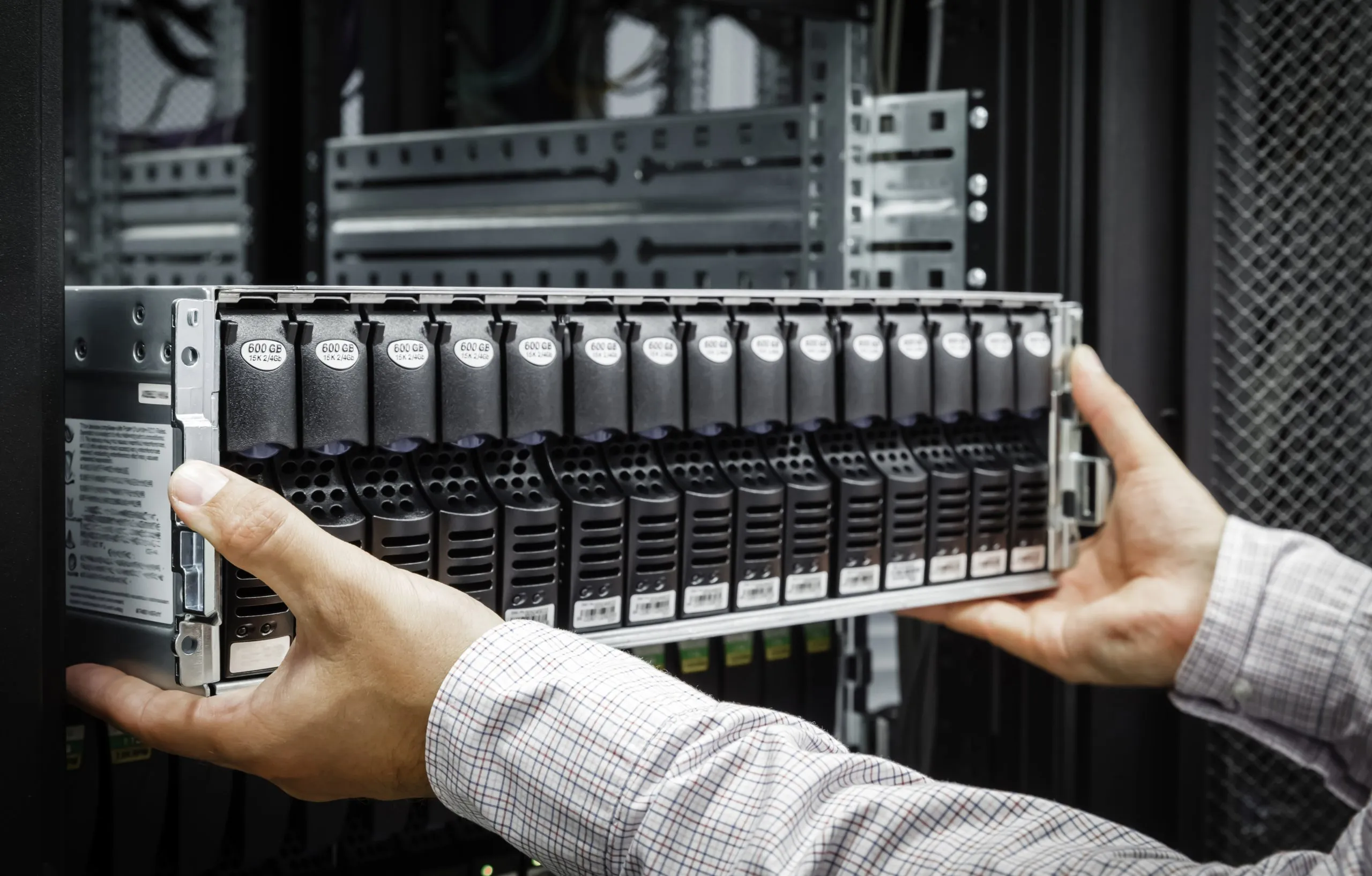Technician installing a server into a data centre rack